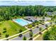 Community pool surrounded by trees and green grass, with lounge chairs and a restroom area at 3041 Winged Teal Ct, Belmont, NC 28012