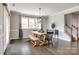Bright dining room with a wooden table, ample windows, and modern pendant lighting fixture at 3041 Winged Teal Ct, Belmont, NC 28012