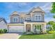 Charming gray two-story home featuring a manicured lawn, attached garage, and welcoming front porch at 3041 Winged Teal Ct, Belmont, NC 28012