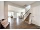 Open-concept foyer with hardwood floors, staircase, and views into the dining and living areas at 3041 Winged Teal Ct, Belmont, NC 28012