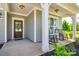 Detailed front door with a floral wreath, complemented by rocking chairs on the covered porch at 3041 Winged Teal Ct, Belmont, NC 28012