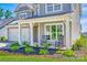 Inviting front porch showcases rocking chairs and decorative landscaping, enhancing the home's curb appeal at 3041 Winged Teal Ct, Belmont, NC 28012