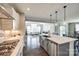 Spacious kitchen with stainless steel appliances, quartz countertops, and an island with a sink at 3041 Winged Teal Ct, Belmont, NC 28012