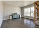 Sunlit living room with hardwood floors, ample natural light, and a stylish display shelf at 3041 Winged Teal Ct, Belmont, NC 28012