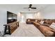 Bright living room boasts a brown sectional, a large TV, and plush carpet, perfect for relaxation at 3041 Winged Teal Ct, Belmont, NC 28012