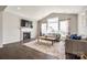 Inviting living room with a fireplace and large windows that fill the room with natural light at 3041 Winged Teal Ct, Belmont, NC 28012