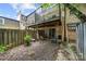 Private backyard featuring a wood fence, mature tree, and a deck with sliding glass door access at 3500 Colony Rd # B, Charlotte, NC 28211