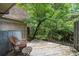 Balcony with worn wooden floor, wicker chair, and tree view at 3500 Colony Rd # B, Charlotte, NC 28211