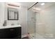 Updated bathroom featuring a modern vanity, glass-enclosed shower with tile surround, and modern lighting at 3500 Colony Rd # B, Charlotte, NC 28211