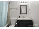 Bathroom with tub and shower, toilet and vanity with medicine cabinet above at 3500 Colony Rd # B, Charlotte, NC 28211