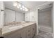 Bright bathroom featuring granite countertops, double sinks, tile floors, and a tub with shower at 3500 Colony Rd # B, Charlotte, NC 28211