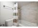 Well-lit bathroom featuring tile walls, a bathtub with shower, and a neutral shower curtain at 3500 Colony Rd # B, Charlotte, NC 28211