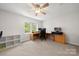 Bedroom featuring neutral carpet, a ceiling fan, and a built in desk at 3500 Colony Rd # B, Charlotte, NC 28211
