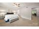 Spacious carpeted bedroom with neutral colors, a gray storage bench and bright natural light at 3500 Colony Rd # B, Charlotte, NC 28211