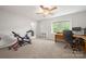 Well lit bedroom with ceiling fan, neutral carpet, desk and workout bike at 3500 Colony Rd # B, Charlotte, NC 28211