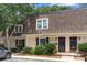 Charming townhouse exterior showcasing brick facade, manicured bushes, and a well-maintained brown shingle roof at 3500 Colony Rd # B, Charlotte, NC 28211