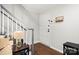 Bright foyer with white paneled door, coat rack and staircase featuring wood floors and gray banister at 3500 Colony Rd # B, Charlotte, NC 28211