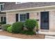 Inviting exterior view of unit B, showcasing manicured greenery and black shutters against a classic brick facade at 3500 Colony Rd # B, Charlotte, NC 28211