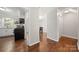 Hallway view into the kitchen and dining area, highlighting the hardwood floors and open layout at 3500 Colony Rd # B, Charlotte, NC 28211