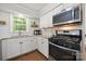 Bright kitchen showcasing white cabinets, a gas range, and modern appliances at 3500 Colony Rd # B, Charlotte, NC 28211