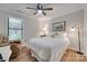 Cozy bedroom features a ceiling fan, natural light from the window, and decorative sunflower art at 353 Tall Oaks Trl, Fort Mill, SC 29715