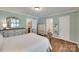 Bright, well-lit bedroom with a connected bath and walk-in closet, light blue walls and wood floors at 353 Tall Oaks Trl, Fort Mill, SC 29715