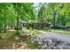 Serene home exterior surrounded by lush trees with a driveway and well-manicured landscaping at 353 Tall Oaks Trl, Fort Mill, SC 29715