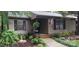 Inviting exterior featuring a charming entrance with well-manicured landscaping, an American flag, and a hanging fern at 353 Tall Oaks Trl, Fort Mill, SC 29715