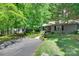 Well-maintained home with landscaped front yard, mature trees, and a paved driveway at 353 Tall Oaks Trl, Fort Mill, SC 29715