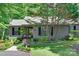 Charming single-story home featuring a well-manicured front yard with mature trees and lush landscaping at 353 Tall Oaks Trl, Fort Mill, SC 29715