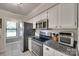 Modern kitchen features granite countertops, stainless steel appliances, and white cabinets at 353 Tall Oaks Trl, Fort Mill, SC 29715