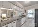 Well-lit kitchen features granite countertops, white cabinetry, tile floor and stainless steel appliances at 353 Tall Oaks Trl, Fort Mill, SC 29715