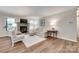 Cozy living room features a stone fireplace, plush seating, and wood-look floors at 353 Tall Oaks Trl, Fort Mill, SC 29715