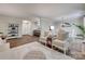 Open-concept living space showcases wood-look floors, comfortable seating, and access to the dining and kitchen areas at 353 Tall Oaks Trl, Fort Mill, SC 29715