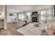 Bright and airy living room with stone fireplace, wood-look floors, and access to the dining area at 353 Tall Oaks Trl, Fort Mill, SC 29715