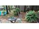 Outdoor seating area featuring charming chairs, a table, and lush greenery, creating a relaxing and inviting space at 353 Tall Oaks Trl, Fort Mill, SC 29715
