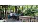 Relaxing outdoor patio featuring comfortable seating, a dining table, and a serene view of the surrounding greenery at 353 Tall Oaks Trl, Fort Mill, SC 29715