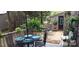 Outdoor patio with dining table and chairs, offering a serene setting surrounded by lush greenery at 353 Tall Oaks Trl, Fort Mill, SC 29715