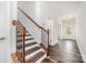 Inviting foyer showcasing hardwood floors, a staircase with wooden banister, and a view of the entryway at 5116 Izzo Ln, Charlotte, NC 28214