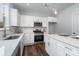 Modern kitchen features white cabinets, stainless steel appliances, and a center island at 5116 Izzo Ln, Charlotte, NC 28214