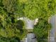 An aerial view showcasing the home nestled among lush trees and the surrounding neighborhood at 5640 Sharon Rd, Charlotte, NC 28210