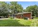 A spacious backyard features a screened-in porch, lush lawn, and mature trees, creating a private outdoor retreat at 5640 Sharon Rd, Charlotte, NC 28210