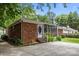 Charming single-story brick home featuring a screened-in porch and well-maintained landscaping at 5640 Sharon Rd, Charlotte, NC 28210