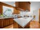 Well-lit kitchen with stainless steel appliances and an island cooktop at 5640 Sharon Rd, Charlotte, NC 28210