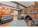 Warm living room with wood paneled walls, brick fireplace, and plush seating at 5640 Sharon Rd, Charlotte, NC 28210