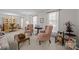 Bright living room featuring elegant furnishings, including wingback chairs and sheer curtains at 5640 Sharon Rd, Charlotte, NC 28210