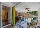 Inviting screened-in porch with a ceiling fan, decorative rug, and comfortable seating at 5640 Sharon Rd, Charlotte, NC 28210