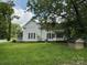 Exterior view of home with porch and large grass yard at 65 Maynard Ave, Ansonville, NC 28170