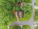 Aerial view of a charming home surrounded by lush greenery and a well-manicured lawn, with a long driveway at 6501 Piney Path Rd, Charlotte, NC 28212