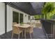 Stylish back deck with a pergola, dining table, chairs, and an outdoor seating area at 6501 Piney Path Rd, Charlotte, NC 28212